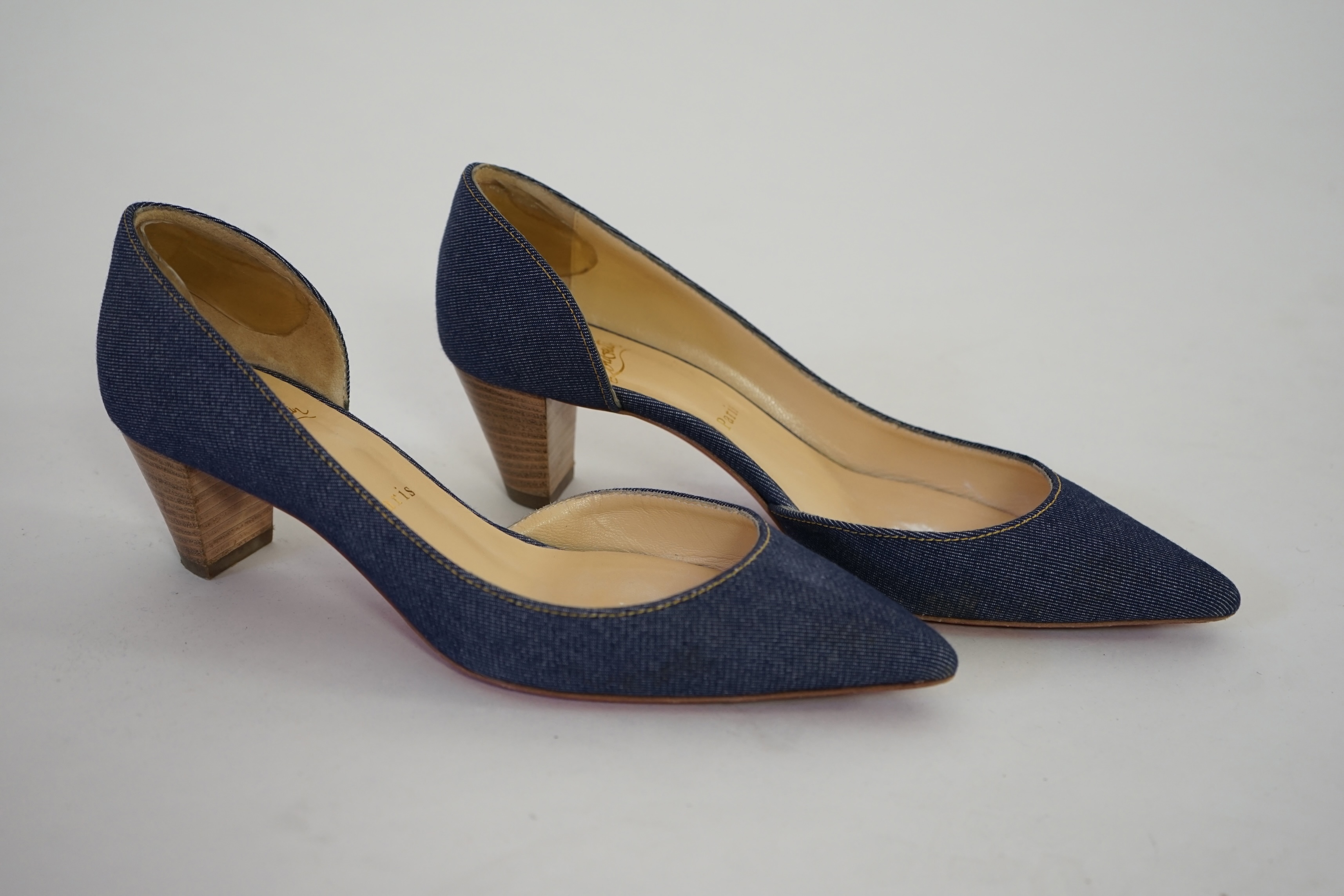 A pair of Christian Louboutin lady's denim pumps with wooden heels, comes with dust bag in original box. Size 39. Proceeds to Happy Paws Puppy Rescue